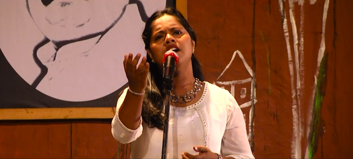Divya singing on stage